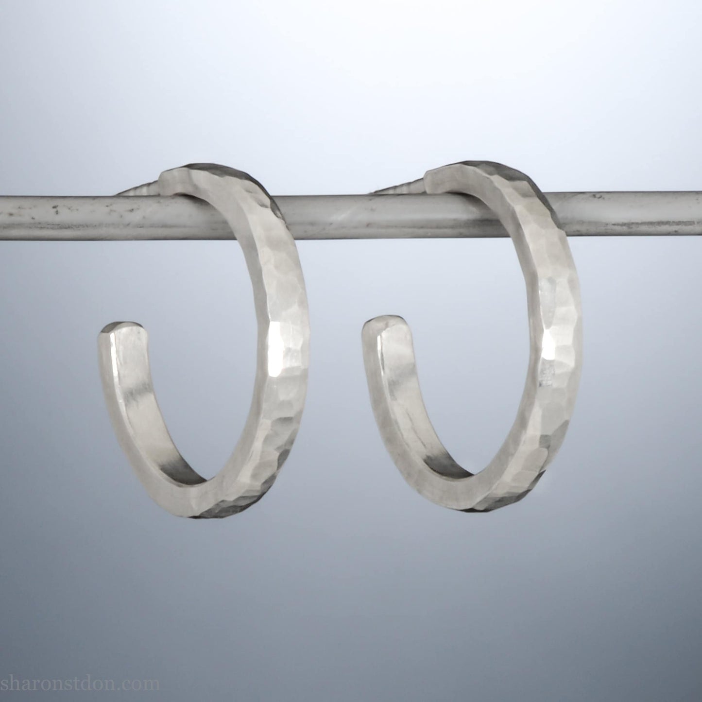 925 sterling silver hoop earrings handmade in North America by Sharon SaintDon. 18mm x 2mm, small, round, shiny, with hammered texture.