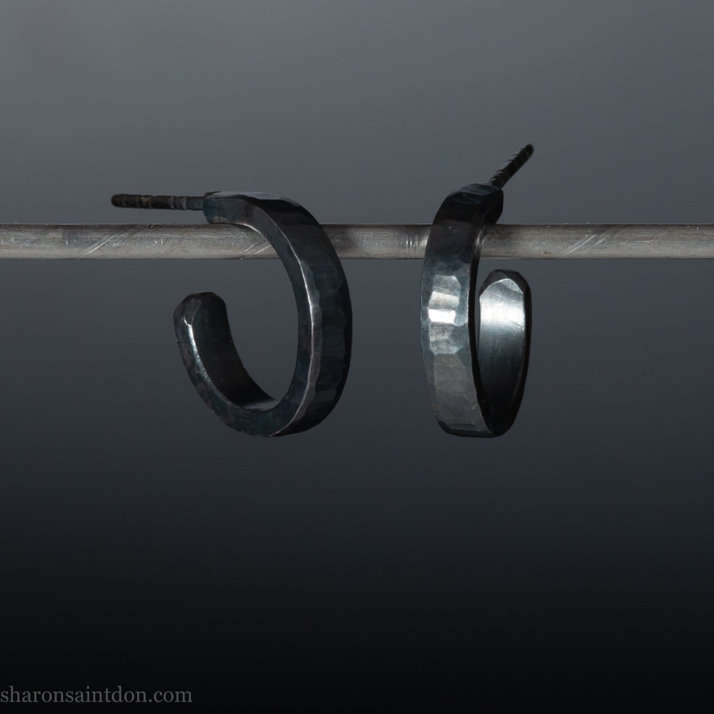 925 sterling silver hoop earrings for men or women, handmade in North America by Sharon SaintDon. 18mm diameter x 3mm wide, small, round, oxidized black with hammered texture.