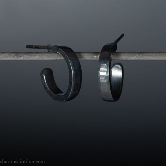925 sterling silver hoop earrings for men or women, handmade in North America by Sharon SaintDon. 18mm diameter x 3mm wide, small, round, oxidized black with hammered texture.