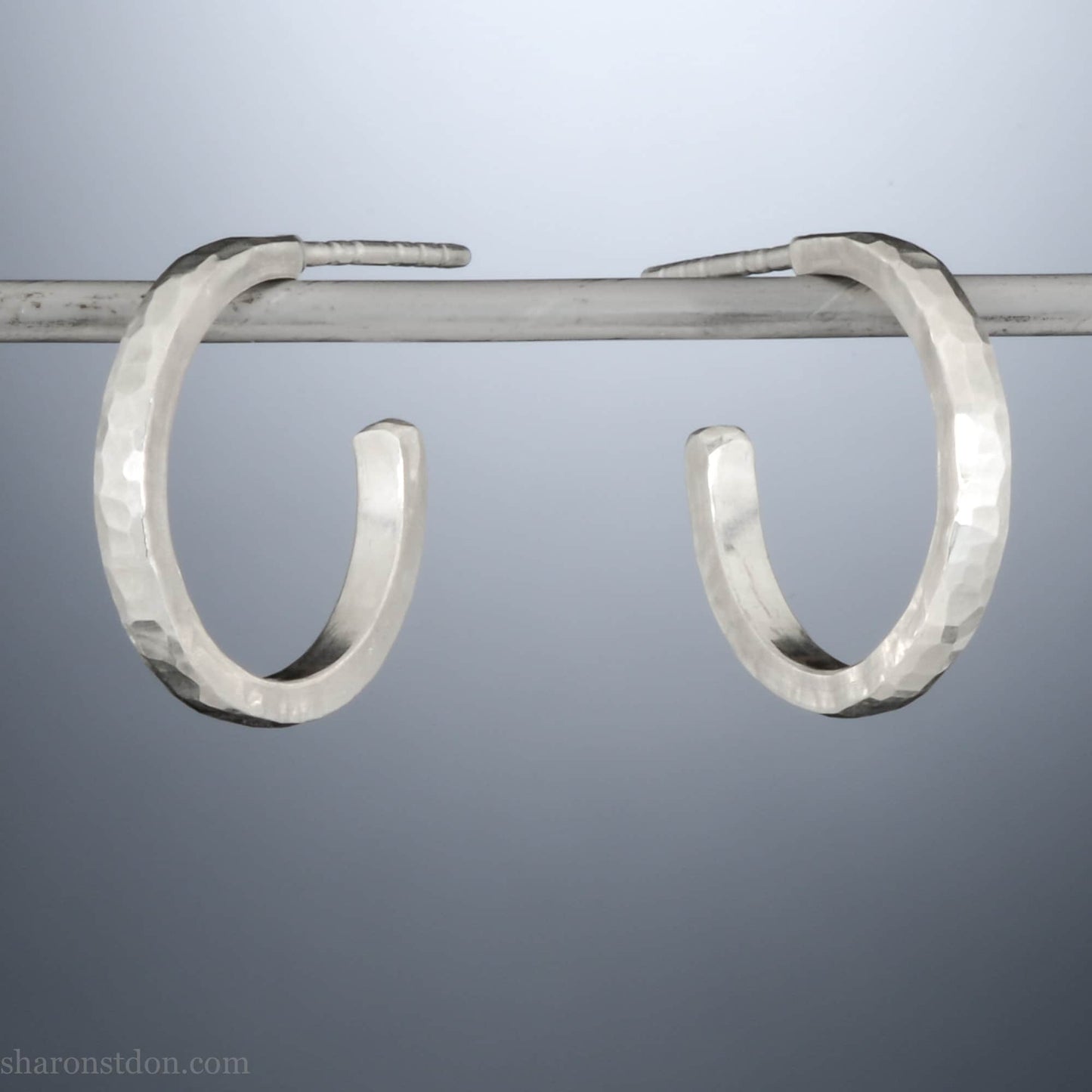 925 sterling silver hoop earrings handmade in North America by Sharon SaintDon. 18mm x 2mm, small, round, shiny, with hammered texture.