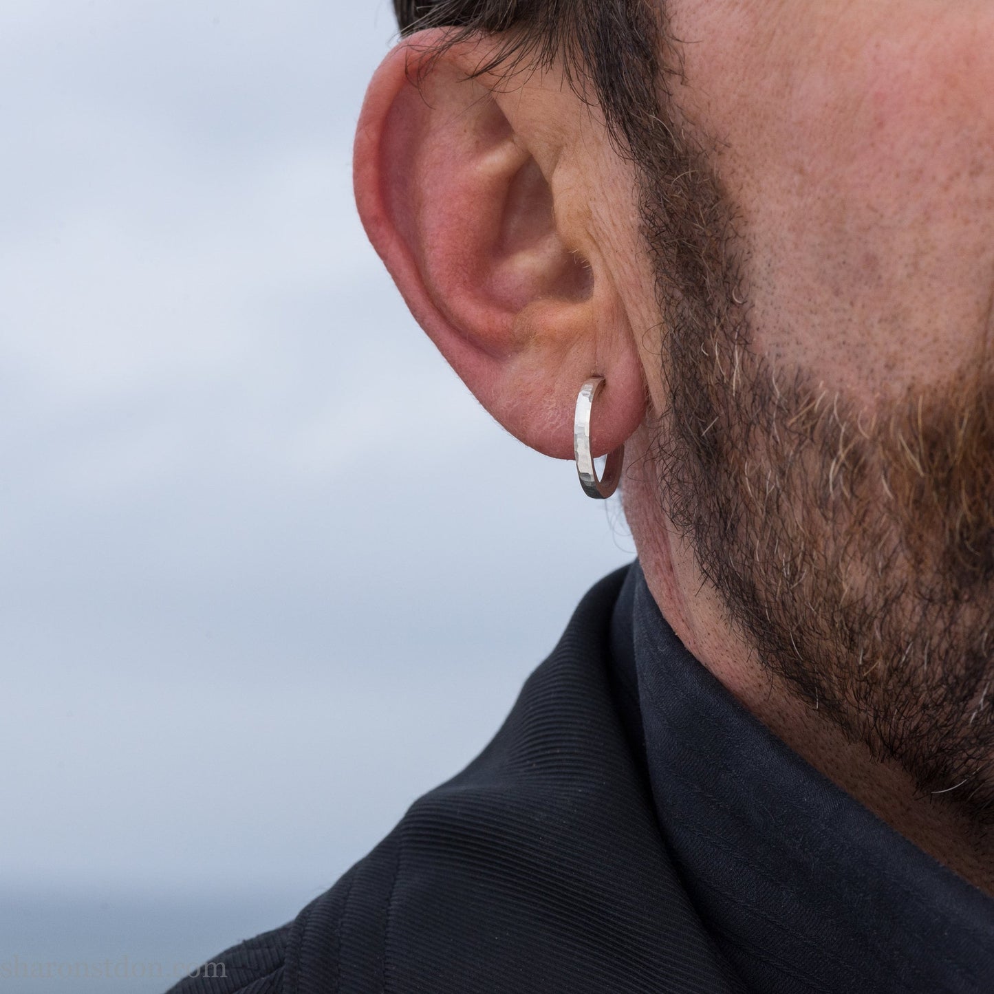 925 sterling silver hoop earrings handmade in North America by Sharon SaintDon. 18mm x 2mm, small, round, shiny, with hammered texture.