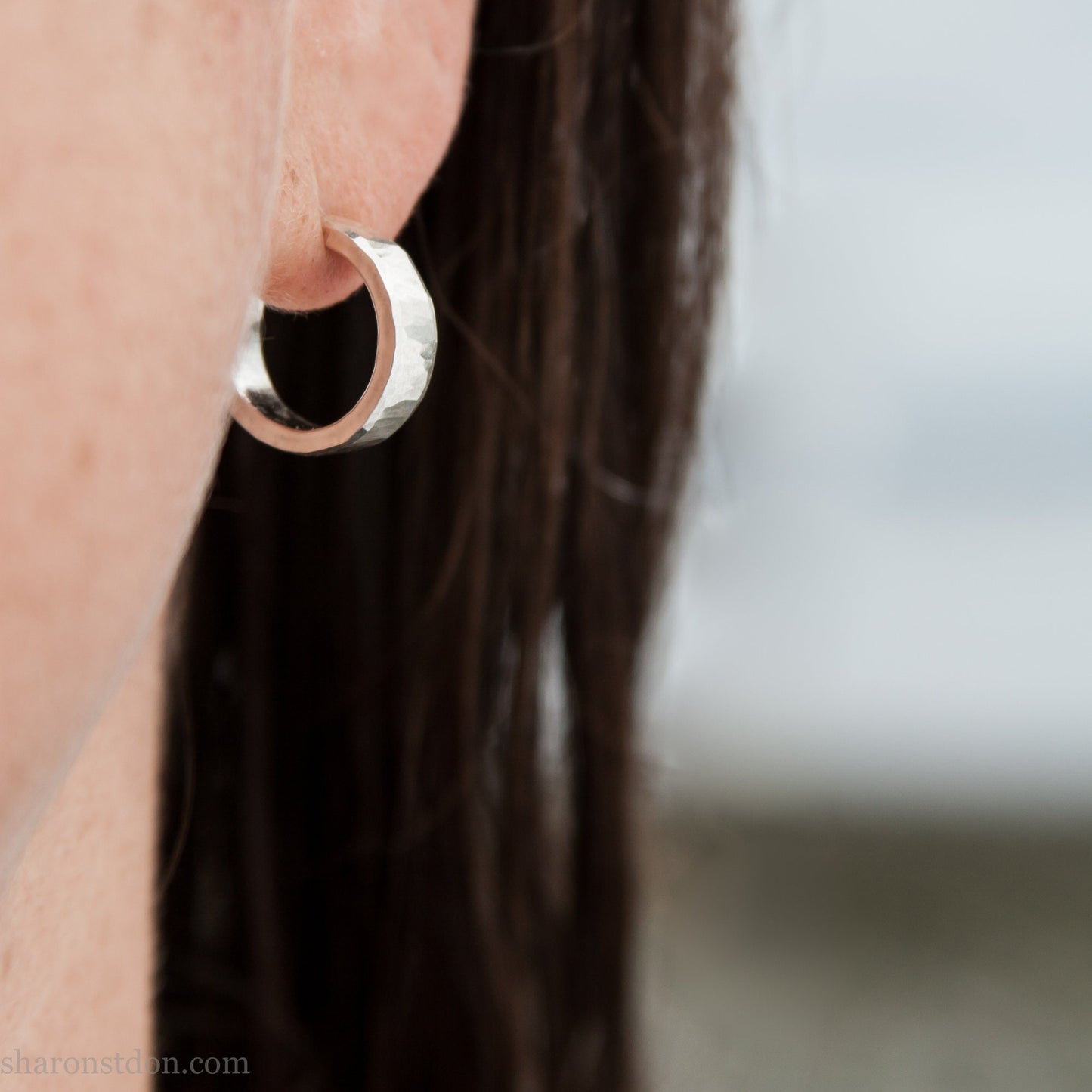 925 sterling silver hoop earrings handmade in North America by Sharon SaintDon. 16mm x 4mm, small, round with hammered texture.