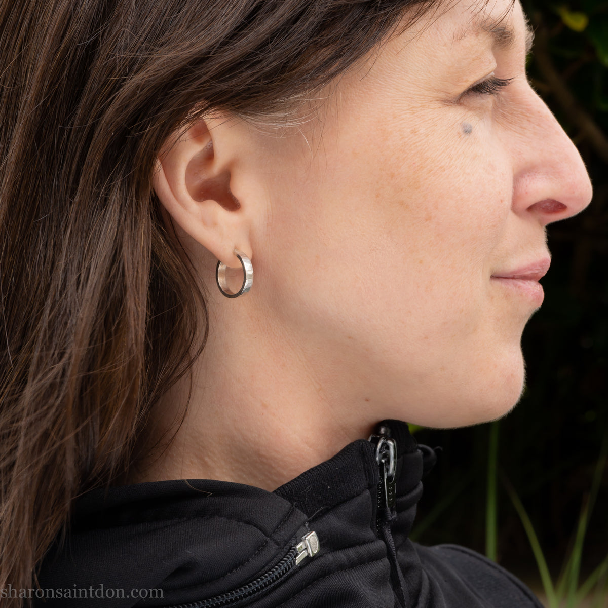 Hand hammered solid 925 sterling silver hoop earrings with a matte, brushed finish. 18mm diameter x 4mm wide x 1.5mm thick, worn on ear.