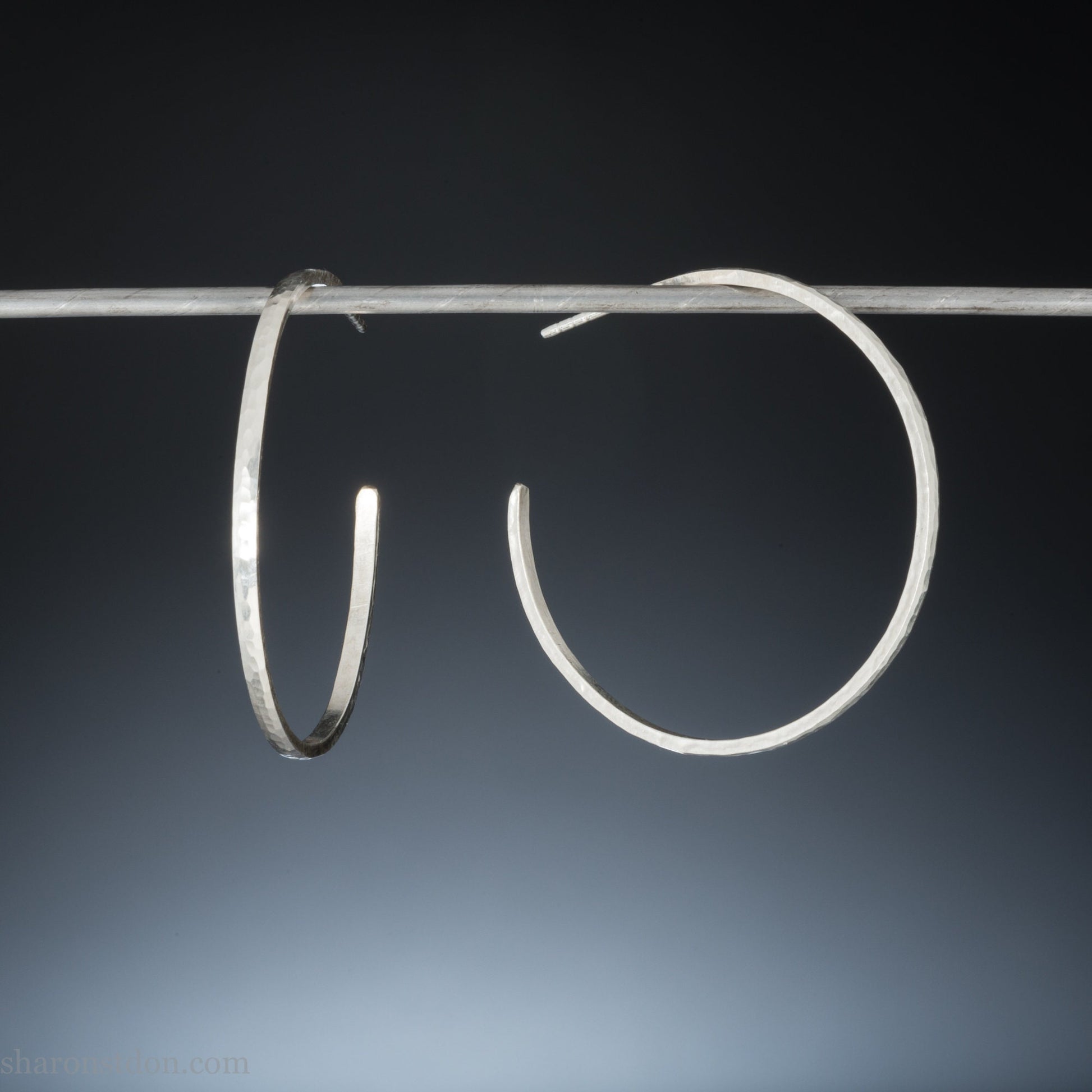 40mm diameter, 2mm wide, handmade 925 sterling silver hoop earrings. Comfortable, lightweight, daily wear hoop earrings with a hammered texture. Made by Sharon SaintDon in North America.