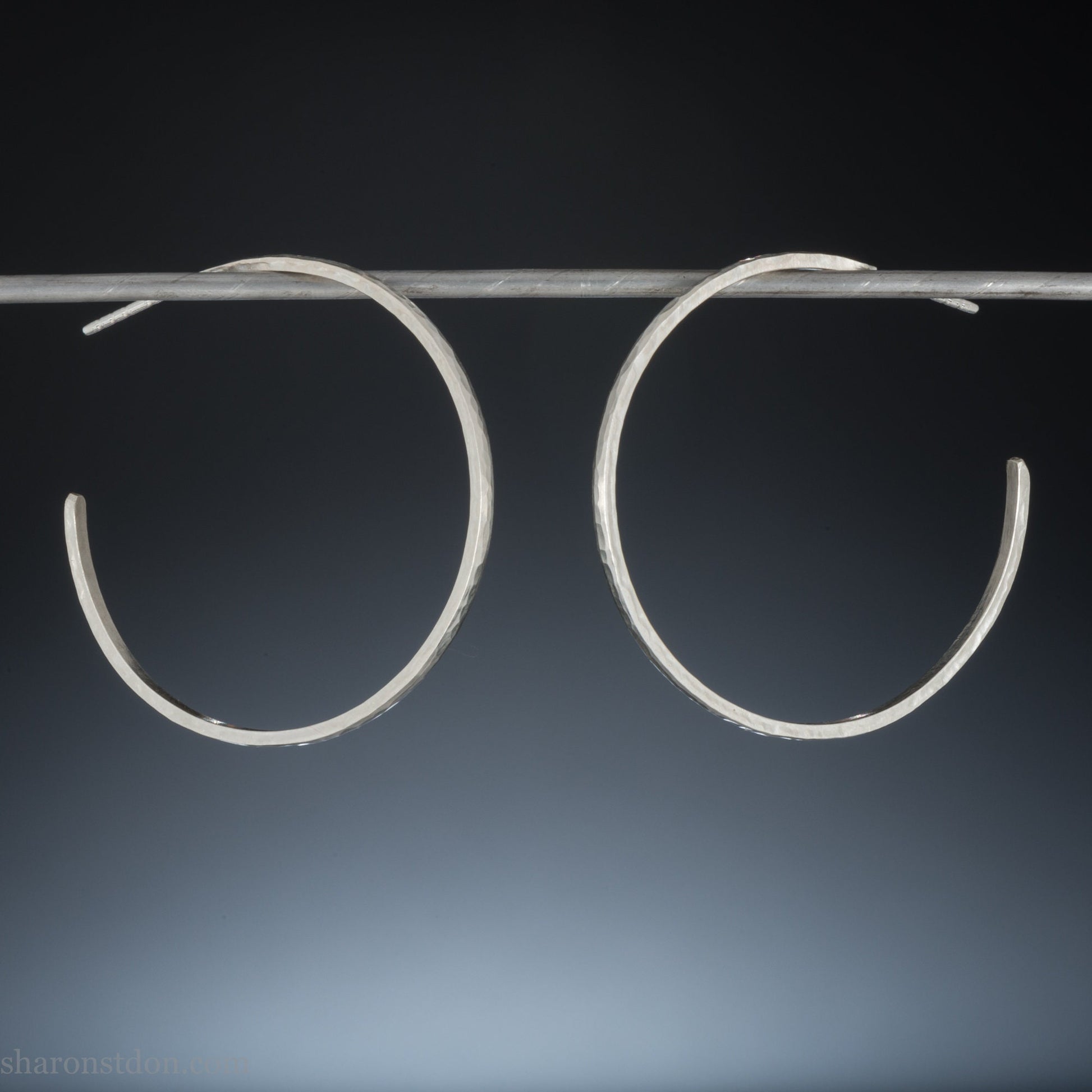 40mm diameter, 2mm wide, handmade 925 sterling silver hoop earrings. Comfortable, lightweight, daily wear hoop earrings with a hammered texture. Made by Sharon SaintDon in North America.