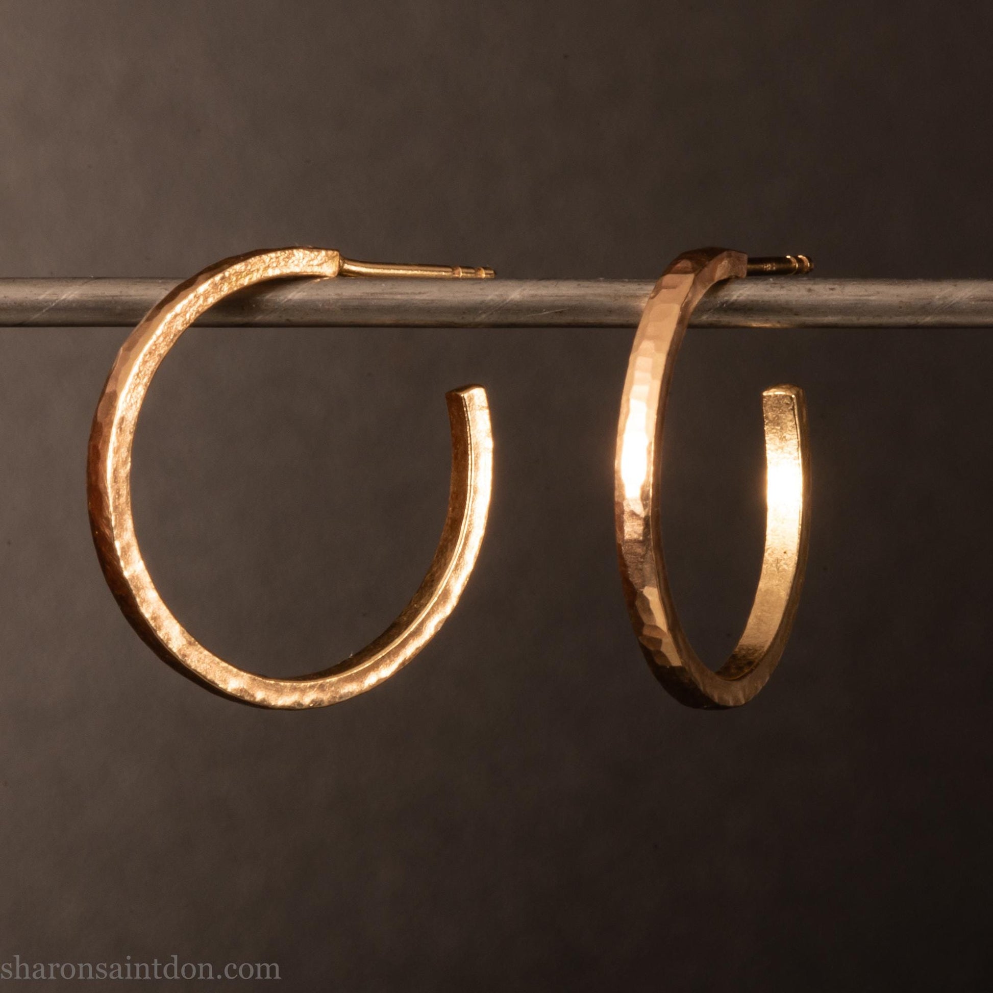 20mm diameter by 1.5mm thick  solid 14k yellow gold hoop earrings. Solid 14k gold posts and backs. Handmade by Sharon SaintDon in North America. Hammered from solid gold with a matte finish.