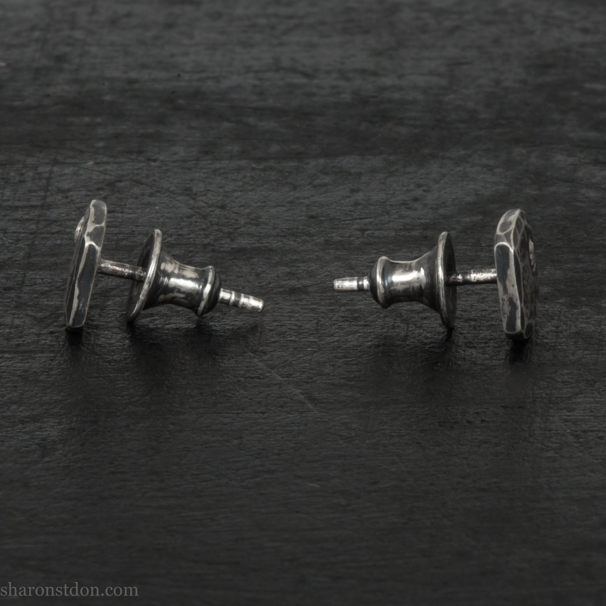 Small 925 sterling silver stud earrings for men with 2mm, imitation diamond gemstone set in the corner. 7mm square, 1.5mm thick with silver posts and backs and hammered, dark, antiqued finish. Handmade by Sharon SaintDon in North America.