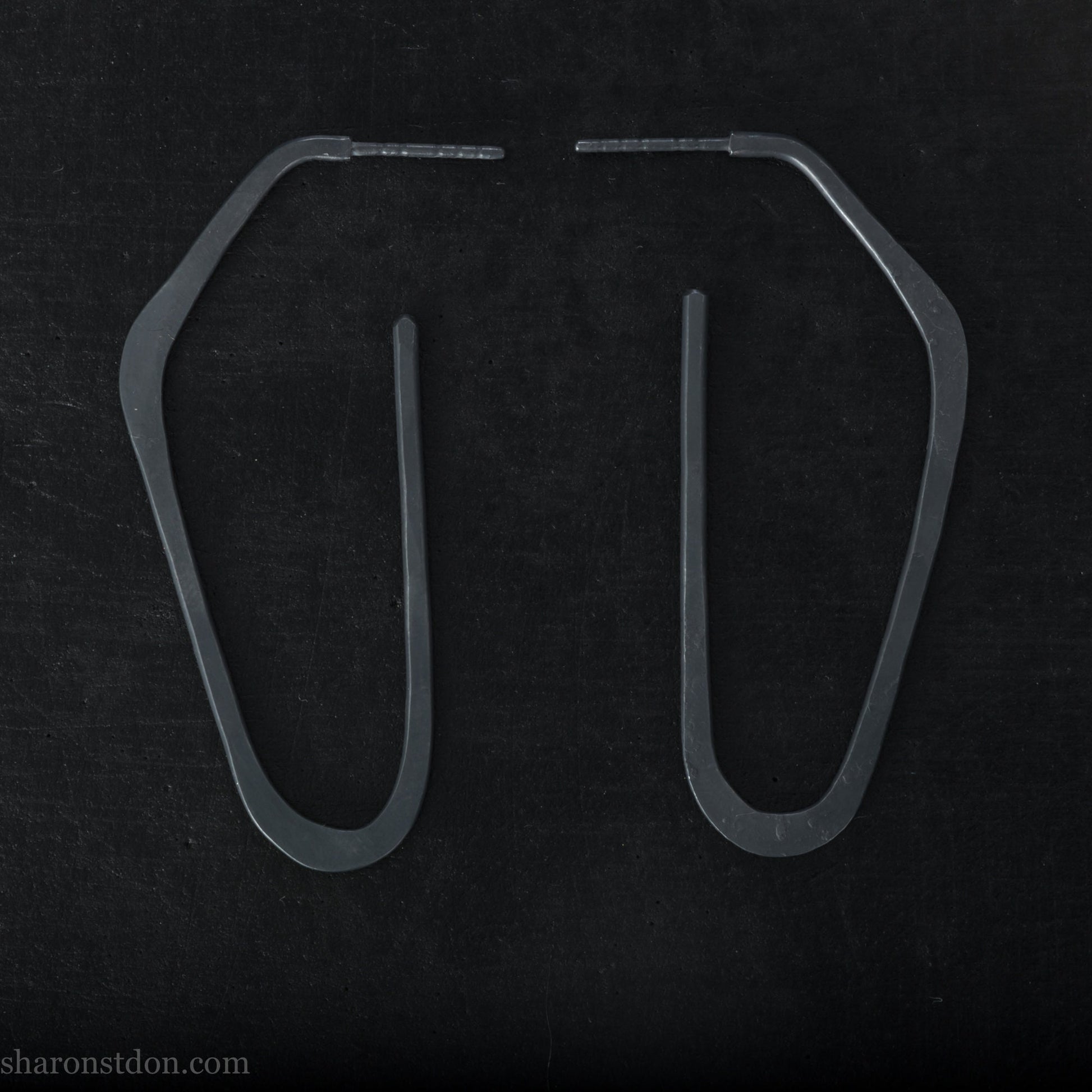 925 sterling silver hoop earrings handmade in North America by Sharon SaintDon. Long, angular, high D shape, oxidized black with hammered texture. SIZE: 47mm high x 19mm wide