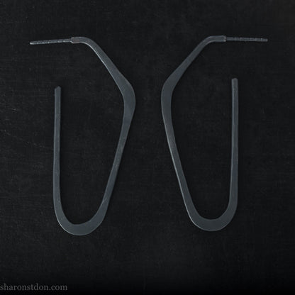 925 sterling silver hoop earrings handmade in North America by Sharon SaintDon. Long, angular, high D shape, oxidized black with hammered texture. SIZE: 47mm high x 19mm wide