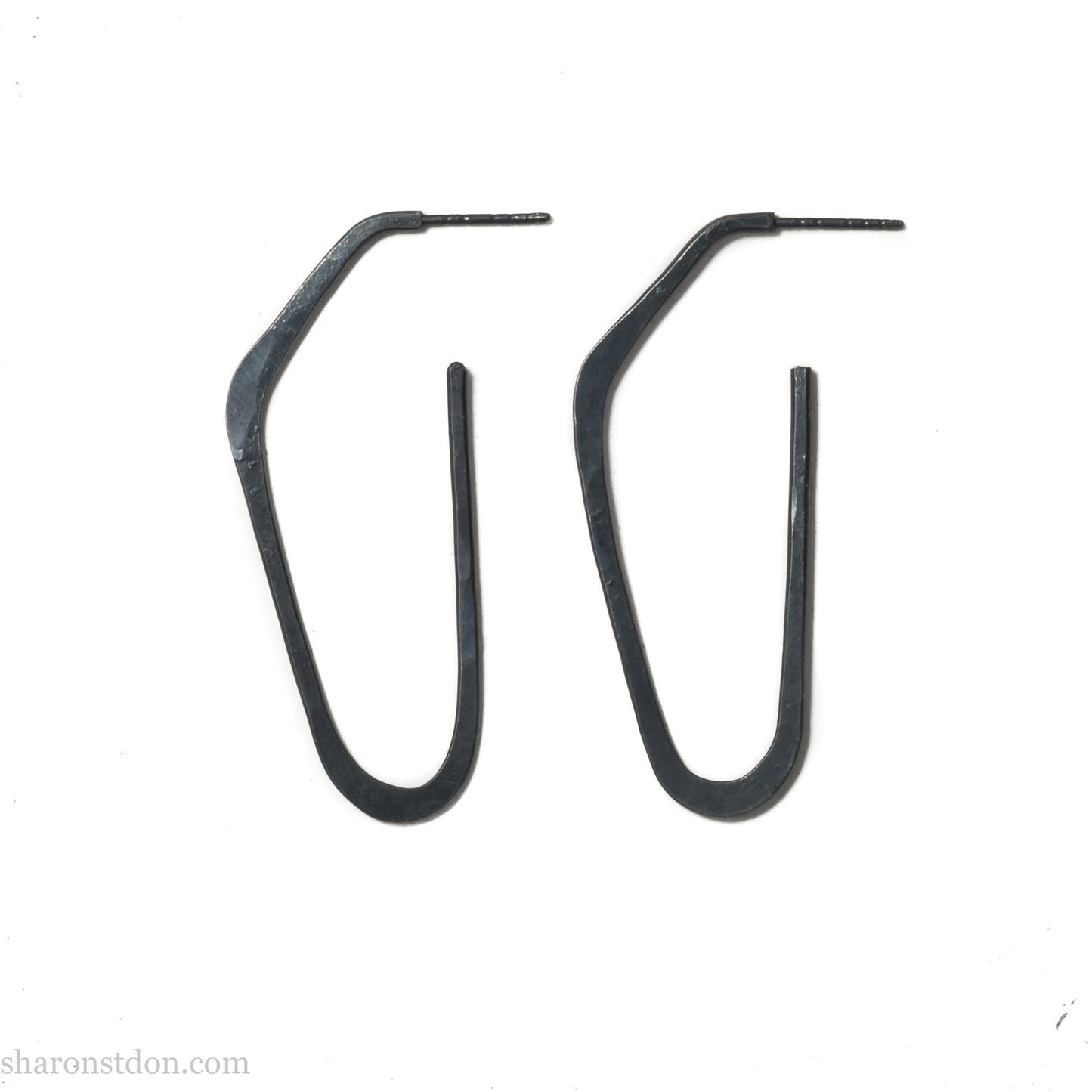 925 sterling silver hoop earrings handmade in North America by Sharon SaintDon. Long, angular, high D shape, oxidized black with hammered texture. SIZE: 47mm high x 19mm wide