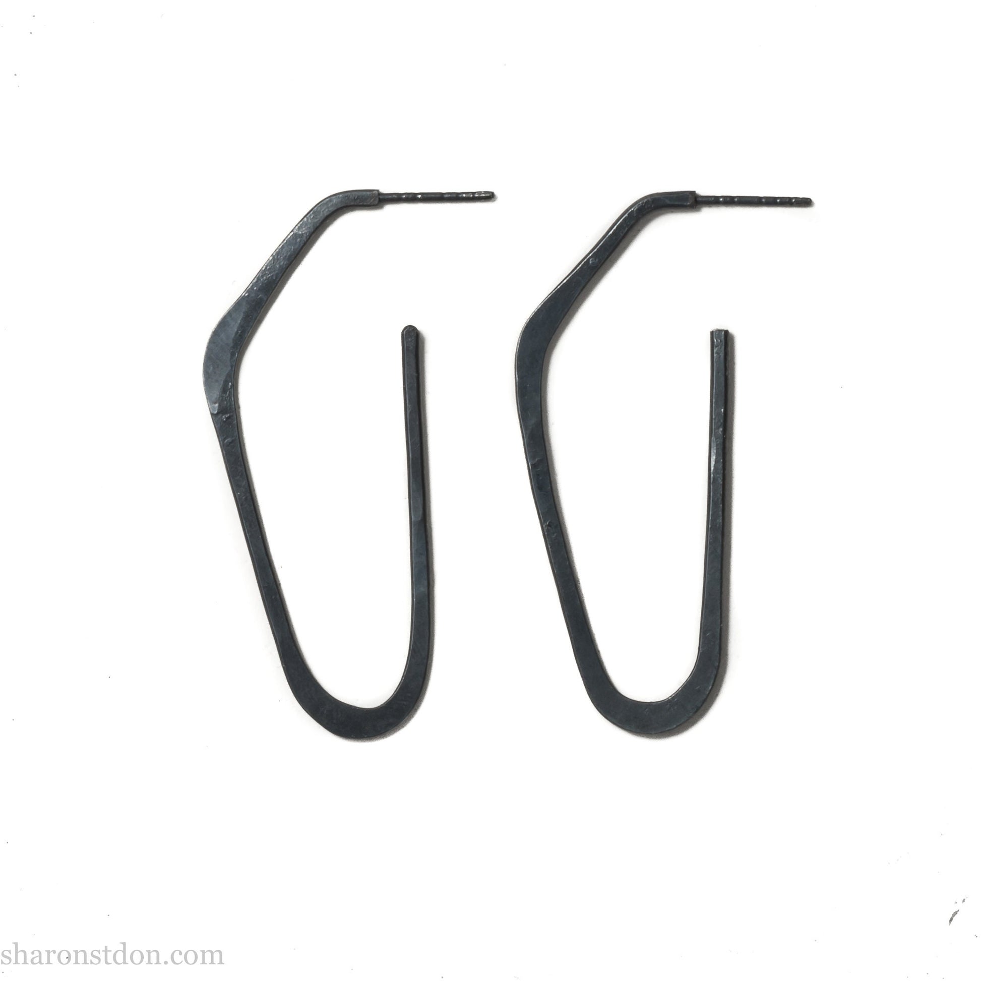 925 sterling silver hoop earrings handmade in North America by Sharon SaintDon. Long, angular, high D shape, oxidized black with hammered texture. SIZE: 47mm high x 19mm wide