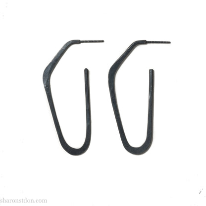 925 sterling silver hoop earrings handmade in North America by Sharon SaintDon. Long, angular, high D shape, oxidized black with hammered texture. SIZE: 47mm high x 19mm wide