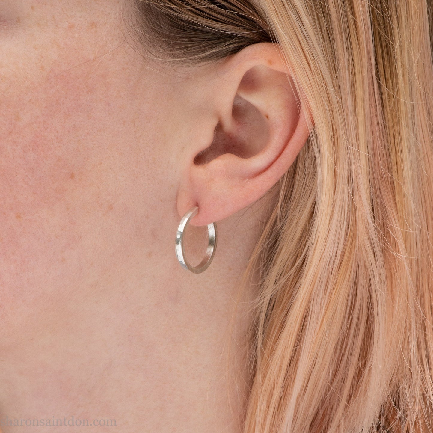 Hand hammered solid 925 sterling silver hoop earrings with a matte, brushed, finish. 20mm diameter x 2mm wide x 1.5mm thick, worn on an ear.