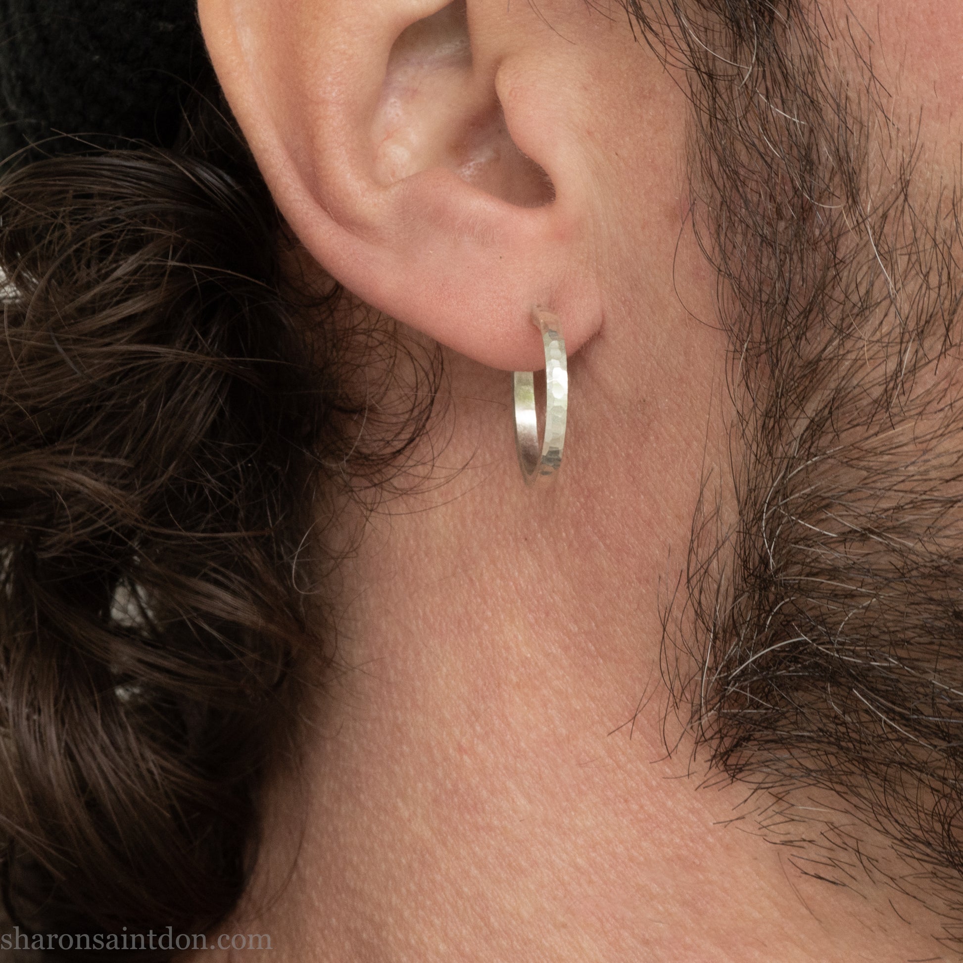 Hand hammered solid 925 sterling silver hoop earrings with a matte, brushed, finish. 20mm diameter x 2mm wide x 1.5mm thick, worn on an ear.