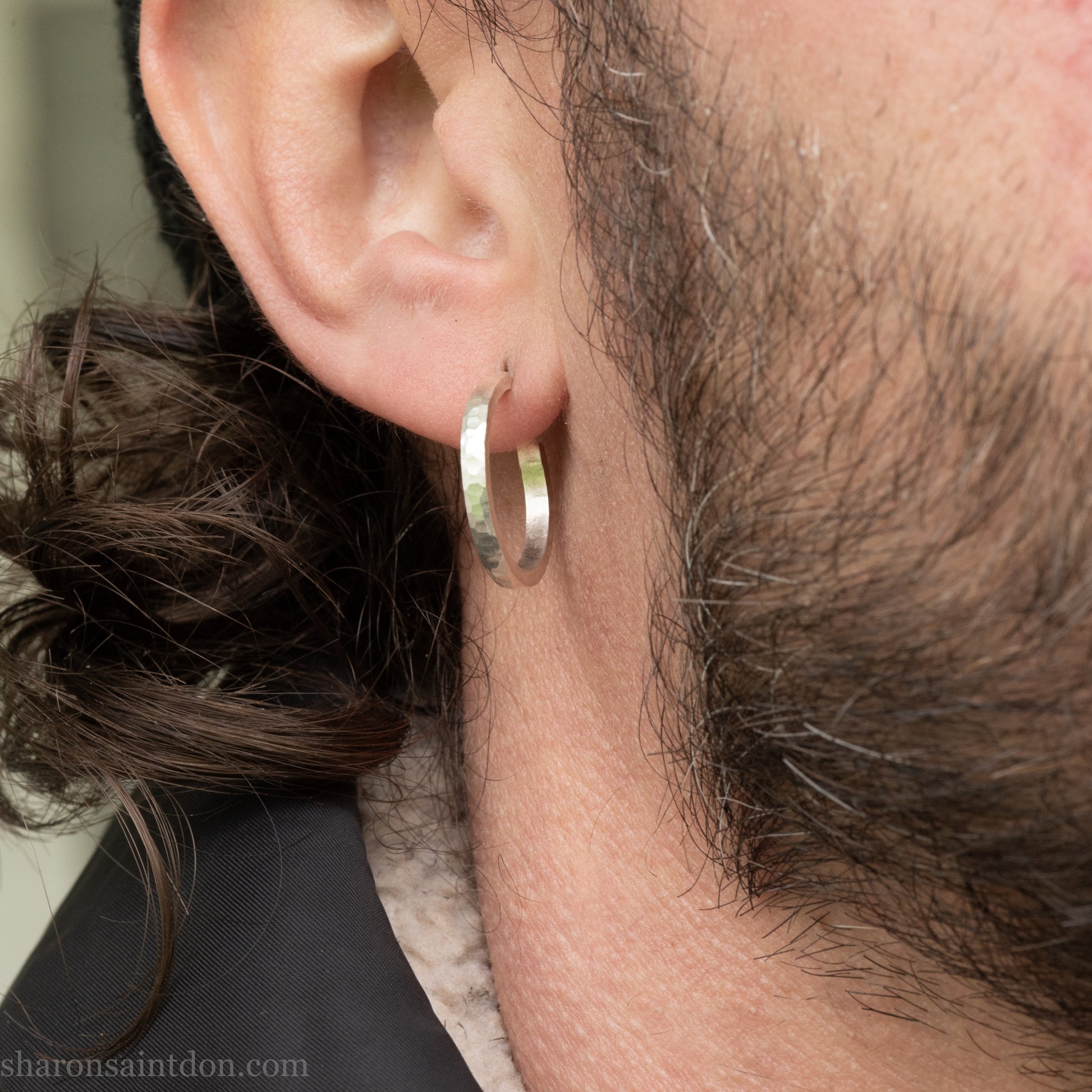 Hand hammered solid 925 sterling silver hoop earrings with a matte, brushed, finish. 20mm diameter x 2mm wide x 1.5mm thick, worn on an ear.