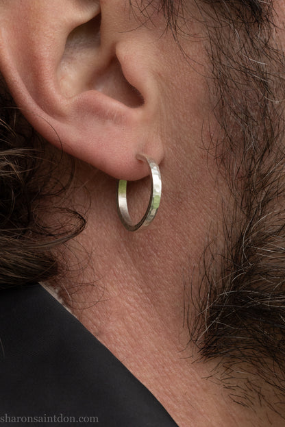 Hand hammered solid 925 sterling silver hoop earrings with a matte, brushed, finish. 20mm diameter x 2mm wide x 1.5mm thick, worn on an ear.