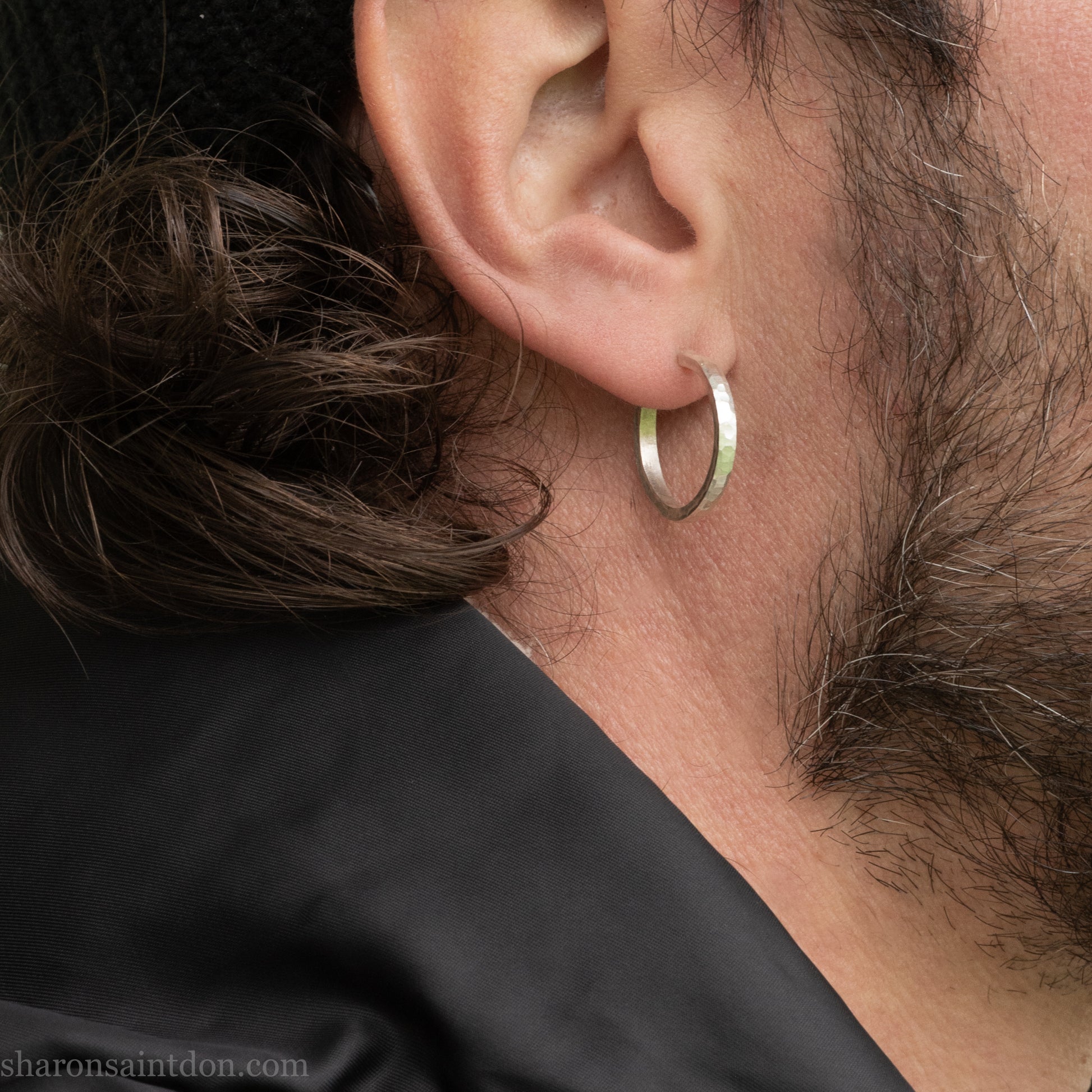 Hand hammered solid 925 sterling silver hoop earrings with a matte, brushed, finish. 20mm diameter x 2mm wide x 1.5mm thick, worn on an ear.