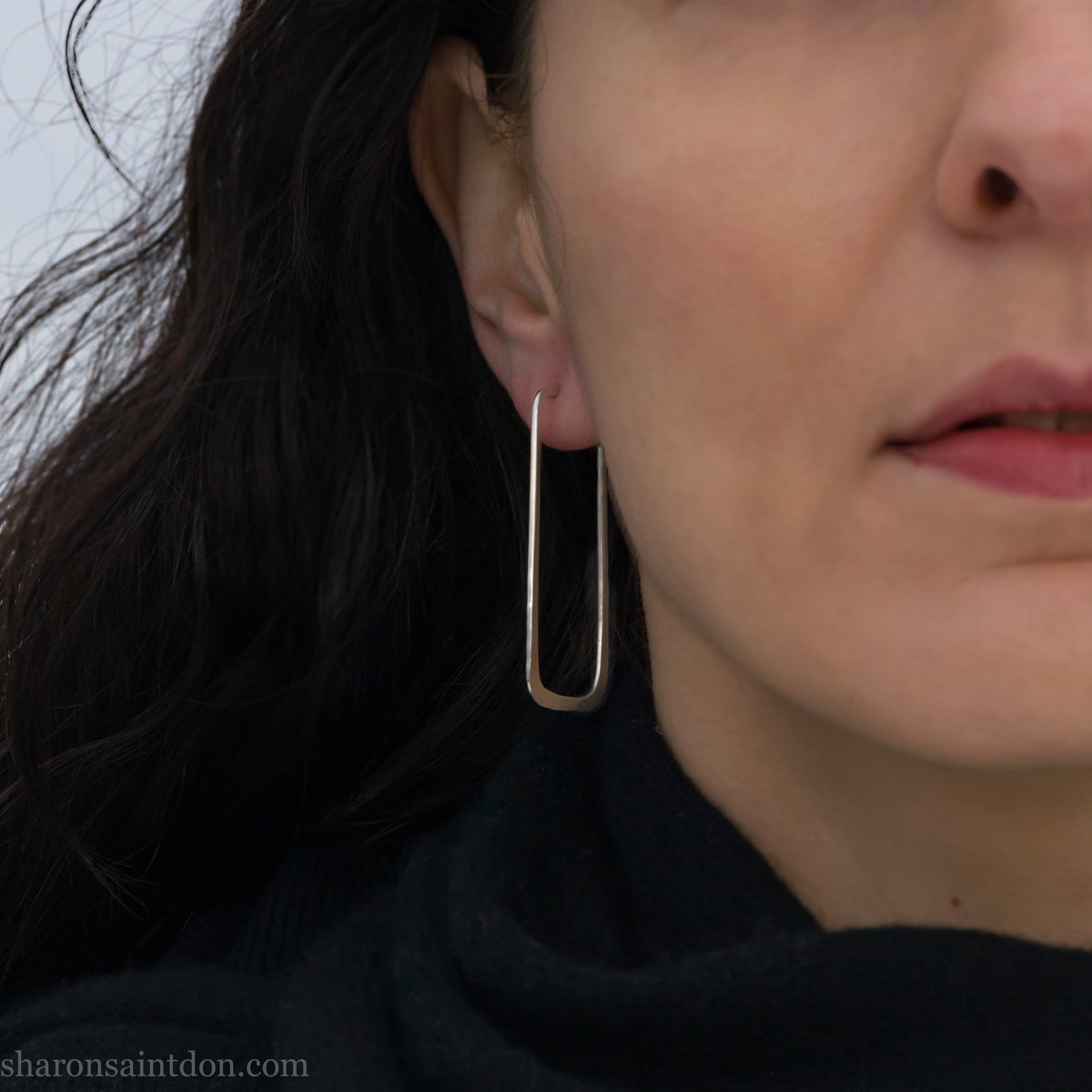 Long rectangle shape 925 sterling silver hoop earrings, worn on ear.