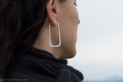 Long rectangle shape 925 sterling silver hoop earrings, worn on ear.
