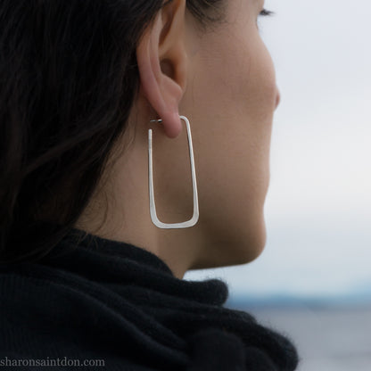 Long rectangle shape 925 sterling silver hoop earrings, worn on ear.