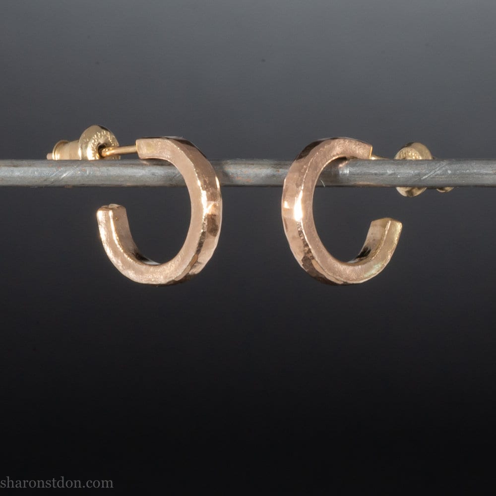 Solid 18k yellow gold hoop earrings set, handmade in North America by Sharon SaintDon. 12mm diameter round, 2mm wide, 1.5mm thick, with hammered texture and matte finish.