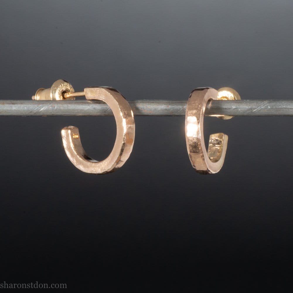 Solid 18k yellow gold hoop earrings set, handmade in North America by Sharon SaintDon. 12mm diameter round, 2mm wide, 1.5mm thick, with hammered texture and matte finish.