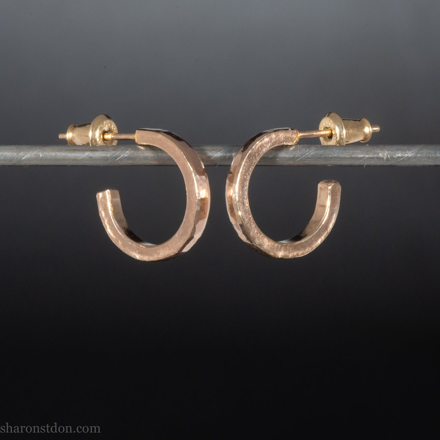 Solid 22k gold hoop earrings handmade in North America by Sharon Saint Don.  14mm diameter round with hammered texture.  18k solid gold posts and locking backs. Handmade in the USA.