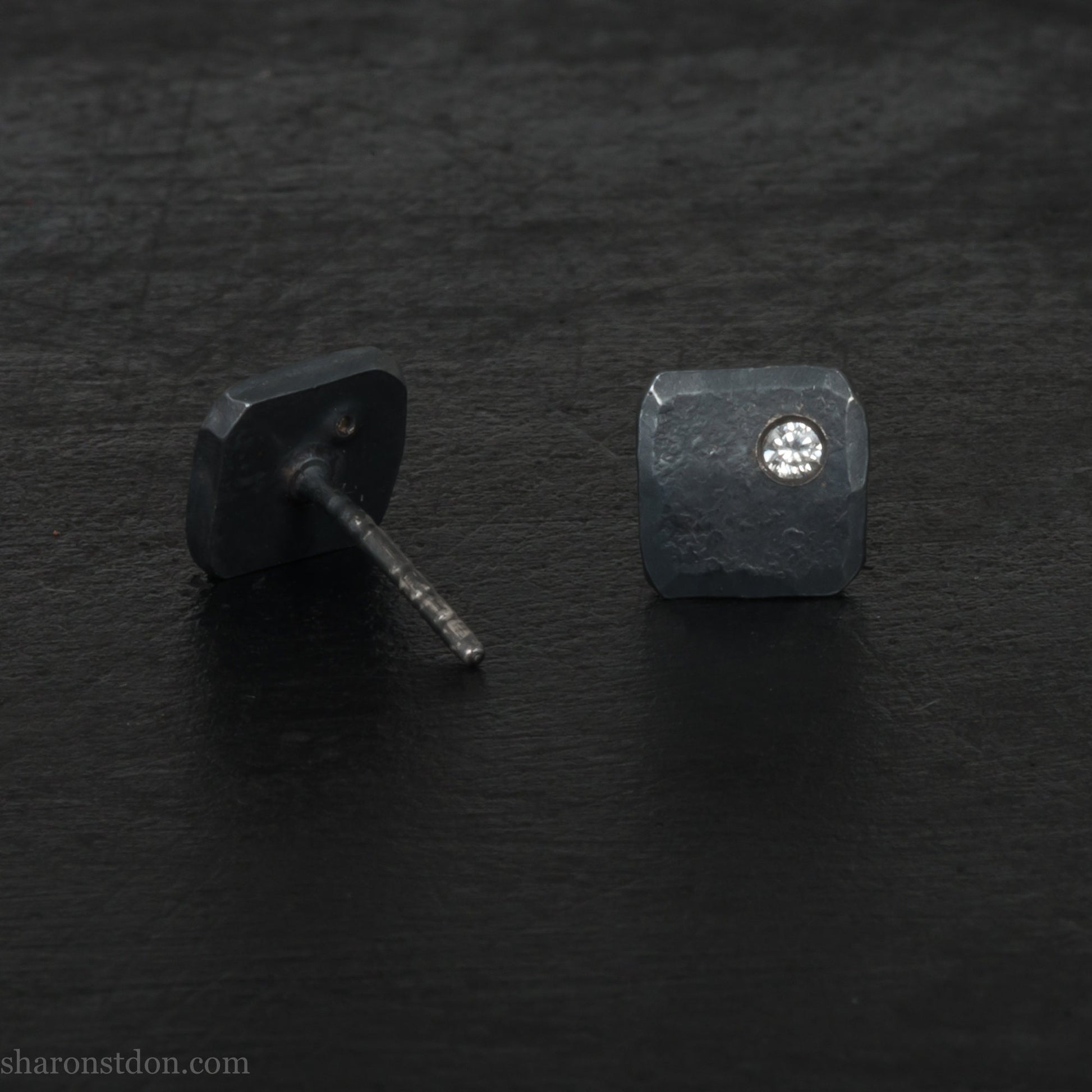Solid 925 sterling silver stud earrings with 2mm round cubic zirconia lab grown gemstone set in the corner. 7mm square, 1.5mm thick, hammered silver with black oxidized tarnished finish. Handmade by Sharon SaintDon in the USA.