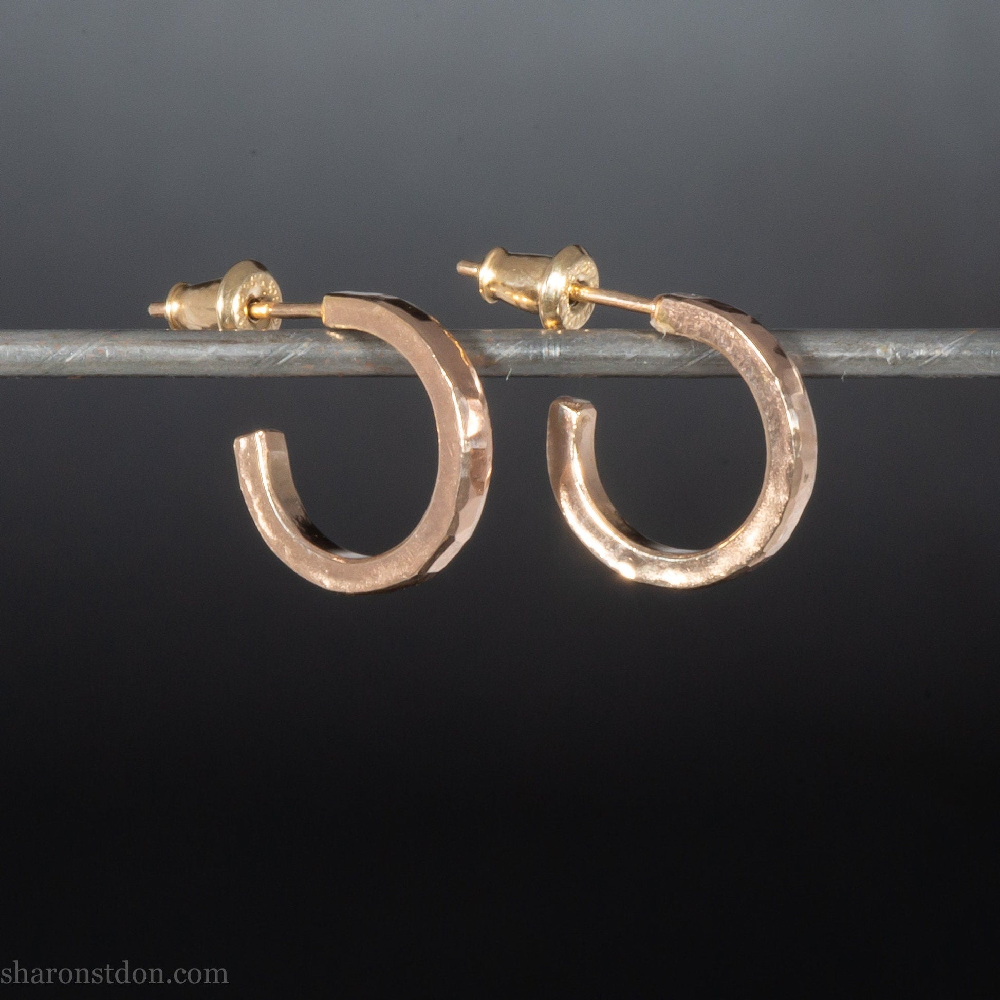 Solid 22k gold hoop earrings handmade in North America by Sharon Saint Don.  14mm diameter round with hammered texture.  18k solid gold posts and locking backs. Handmade in the USA.