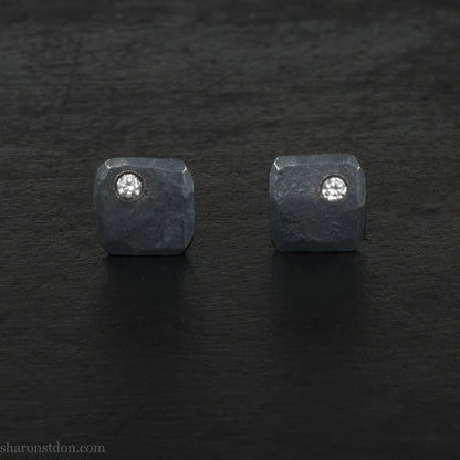 Solid 925 sterling silver stud earrings with 2mm round cubic zirconia lab grown gemstone set in the corner. 7mm square, 1.5mm thick, hammered silver with black oxidized tarnished finish. Handmade by Sharon SaintDon in the USA.