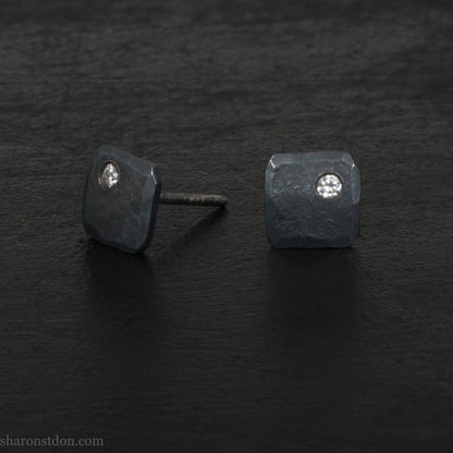 Solid 925 sterling silver stud earrings with 2mm round cubic zirconia lab grown gemstone set in the corner. 7mm square, 1.5mm thick, hammered silver with black oxidized tarnished finish. Handmade by Sharon SaintDon in the USA.