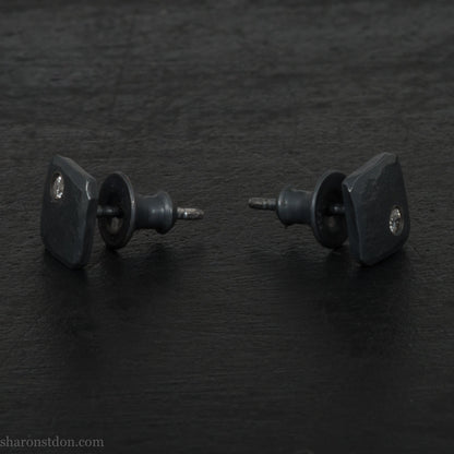 Hammered solid silver and gemstone stud earrings with a 2mm cubic zirconia set in the corner. 7 x 7mm square x 1.5mm thick silver with an oxidized black finish. Solid silver posts and backs. Handmade by Sharon SaintDon in North America.