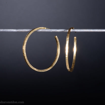 40mm diameter by 1.5mm thick handmade solid 18k yellow gold hoop earrings. Handmade by Sharon SaintDon in North America. Hammered from solid gold with a matte finish.