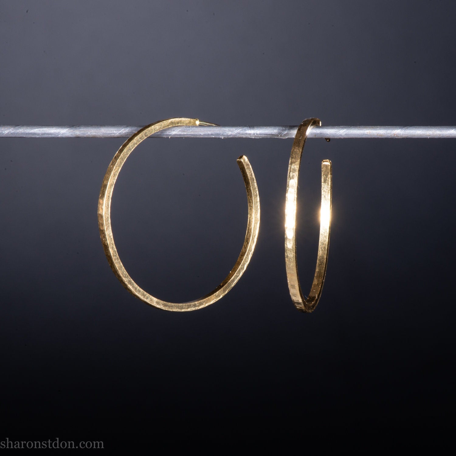 40mm diameter by 1.5mm thick handmade solid 14k yellow gold hoop earrings. Handmade by Sharon SaintDon in North America. Hammered from solid gold with a matte finish.