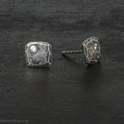 Hammered 925 sterling silver stud earrings with 2mm round lab grown cubic zirconia gemstone set in the corner. 7mm square, 1.5mm thick, dark antique finish, silver posts and backs. Handmade by Sharon SaintDon in North America