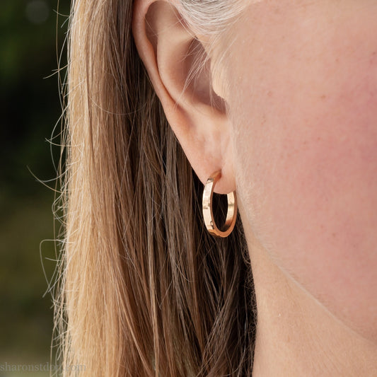 Solid 22k yellow gold hoop earrings set, handmade in North America by Sharon SaintDon.18mm diameter round, 2mm wide, 1.5mm thick, with hammered texture and matte finish.