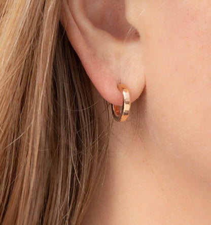 Solid 18k yellow gold hoop earrings set, handmade in North America by Sharon SaintDon. 12mm diameter round, 2mm wide, 1.5mm thick, with hammered texture and matte finish.