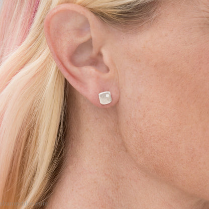 925 sterling silver stud earrings with 2mm round, imitation diamond gemstone set in the corner. 7mm square, 1.5mm thick with hammered texture, matte brushed finish, solid sterling silver posts and backs.  Handmade by Sharon SaintDon in North America.