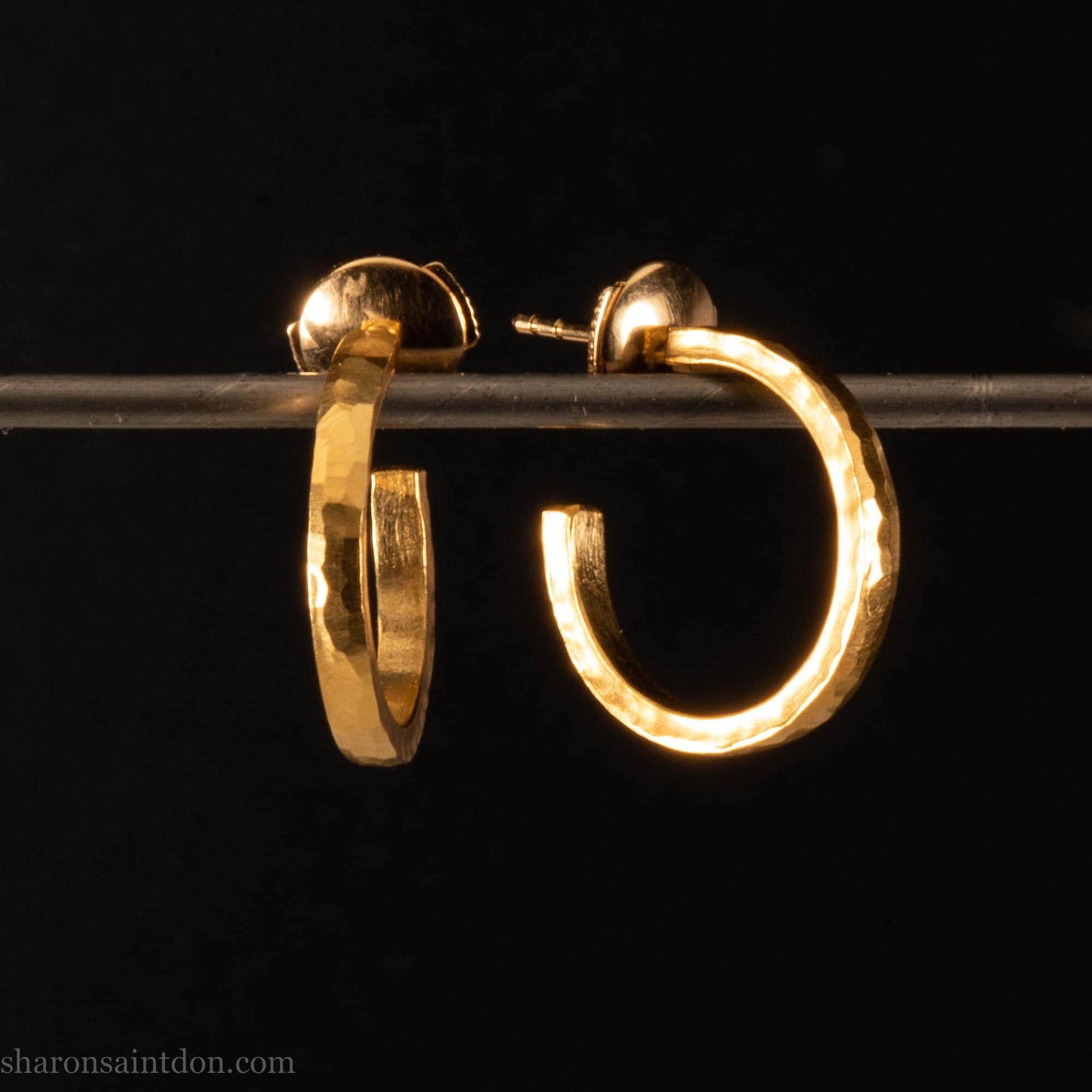 Solid yellow gold hoop earrings handmade in North America by Sharon SaintDon. Hammered solid 18k yellow gold, 18mm diameter round. Matte brushed finish and solid 18k gold posts and locking backs.