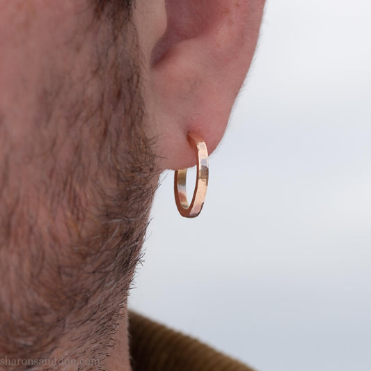 Solid yellow gold hoop earrings handmade in North America by Sharon SaintDon. Hammered solid 18k yellow gold, 18mm diameter round. Matte brushed finish and solid 18k gold posts and locking backs.