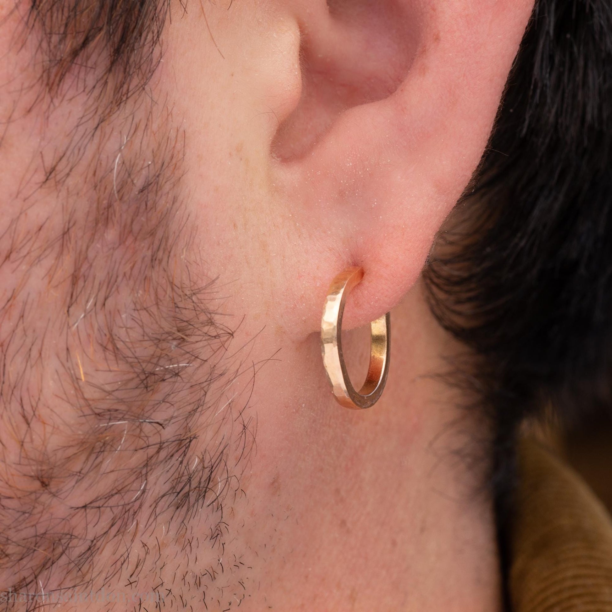 Solid yellow gold hoop earrings handmade in North America by Sharon SaintDon. Hammered solid 18k yellow gold, 18mm diameter round. Matte brushed finish and solid 18k gold posts and locking backs.