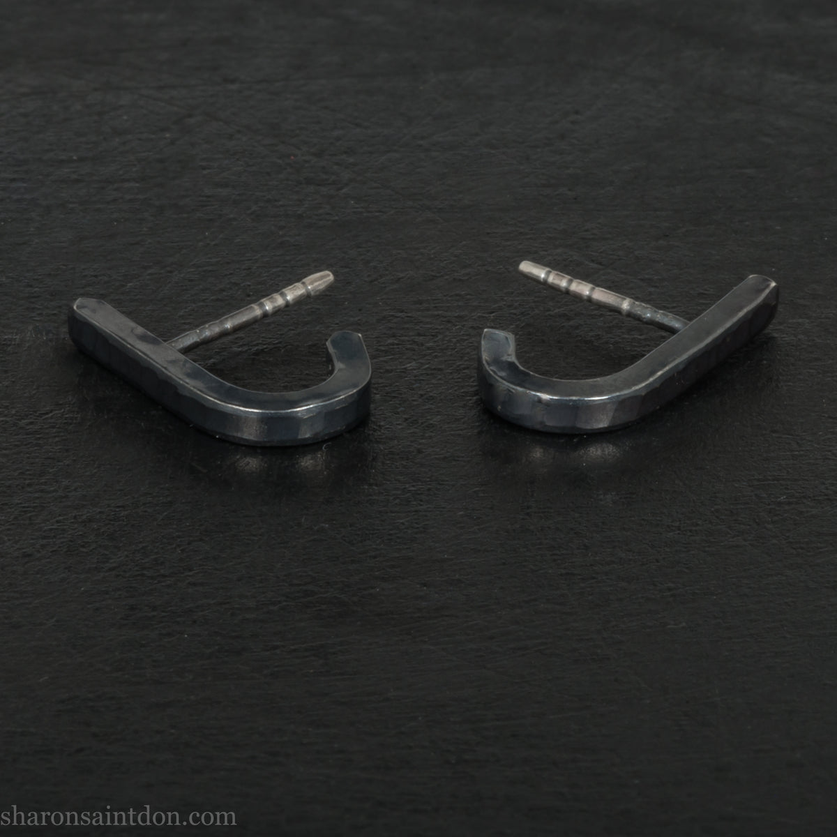 Hand hammered oxidized black sterling silver J-Curve hoop earrings, oxidized black patina.