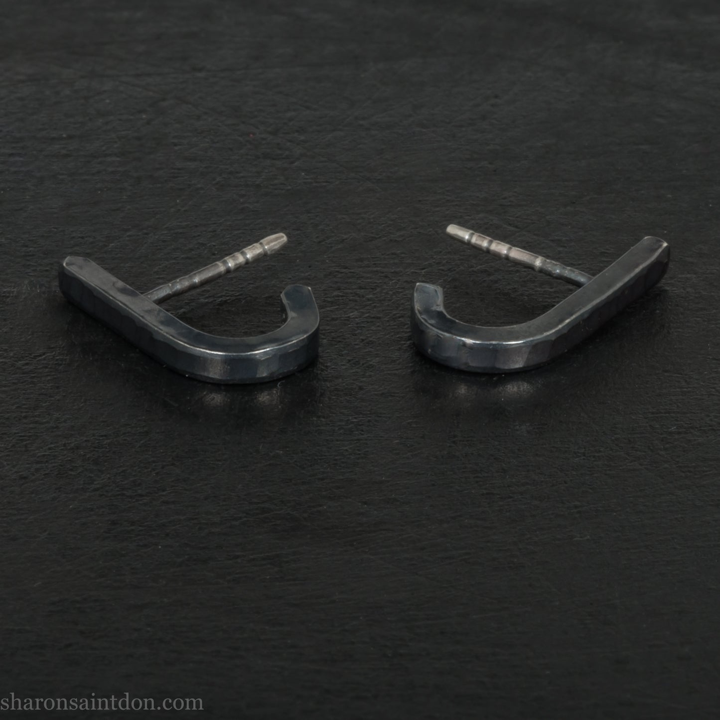 Hand hammered oxidized black sterling silver J-Curve hoop earrings, oxidized black patina.
