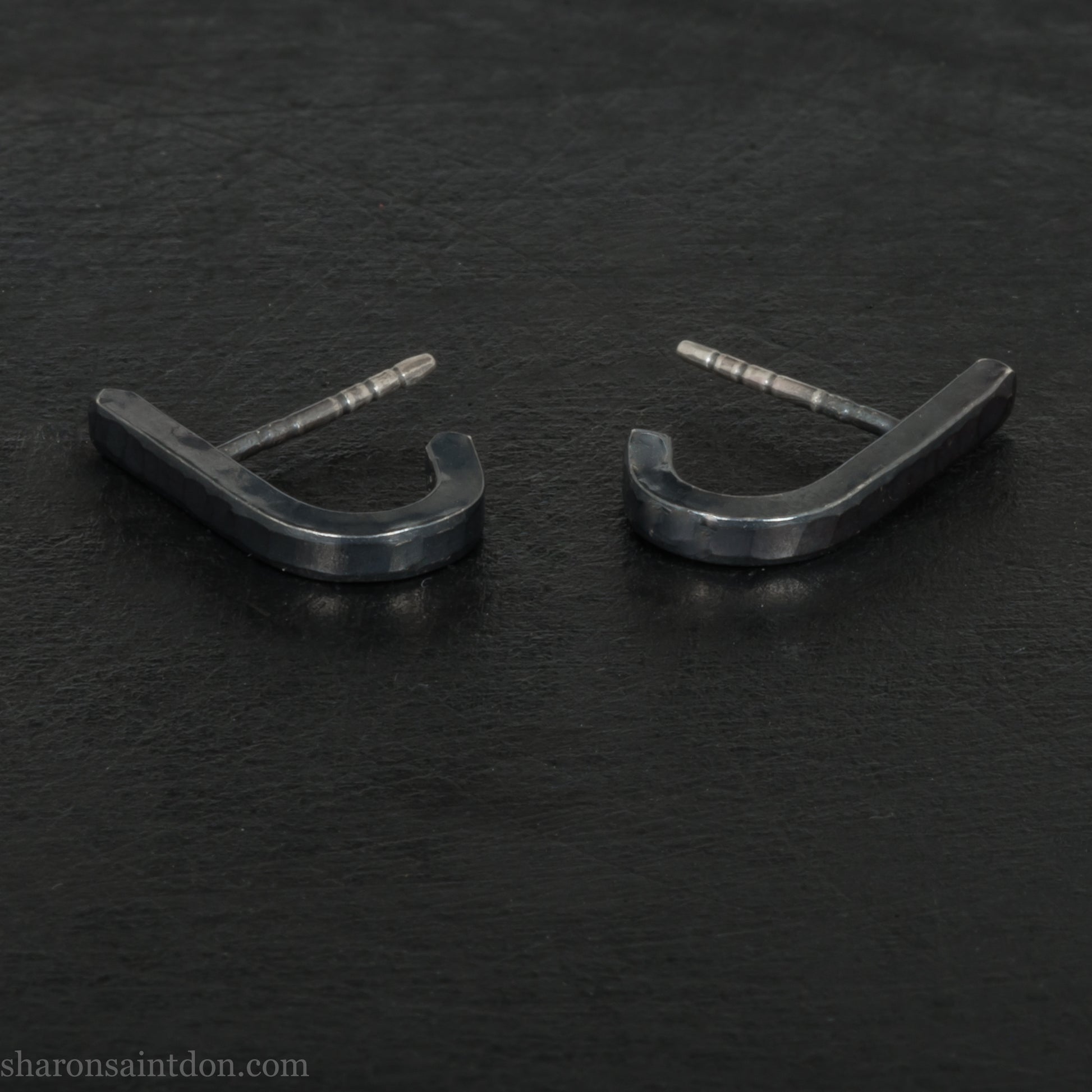 Hand hammered oxidized black sterling silver J-Curve hoop earrings, oxidized black patina.