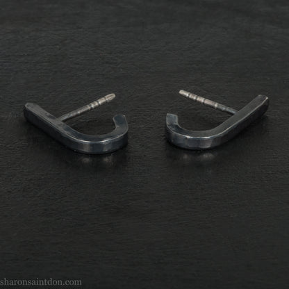 Hand hammered oxidized black sterling silver J-Curve hoop earrings, oxidized black patina.