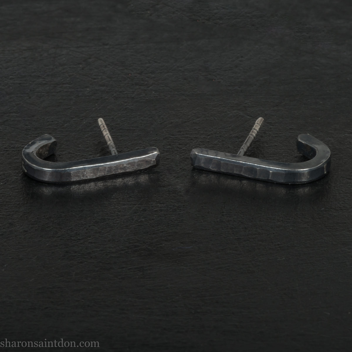 Hand hammered oxidized black sterling silver J-Curve hoop earrings, oxidized black patina.