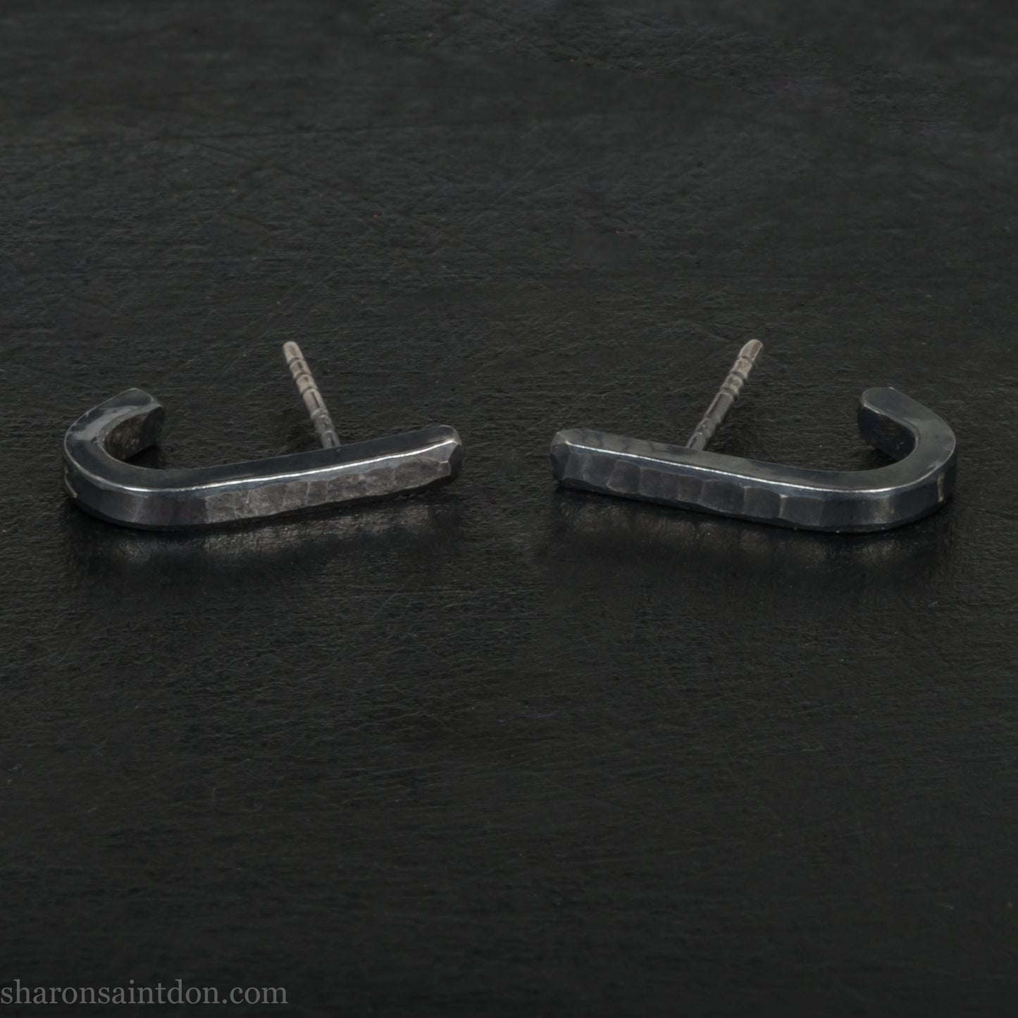 Hand hammered oxidized black sterling silver J-Curve hoop earrings, oxidized black patina.