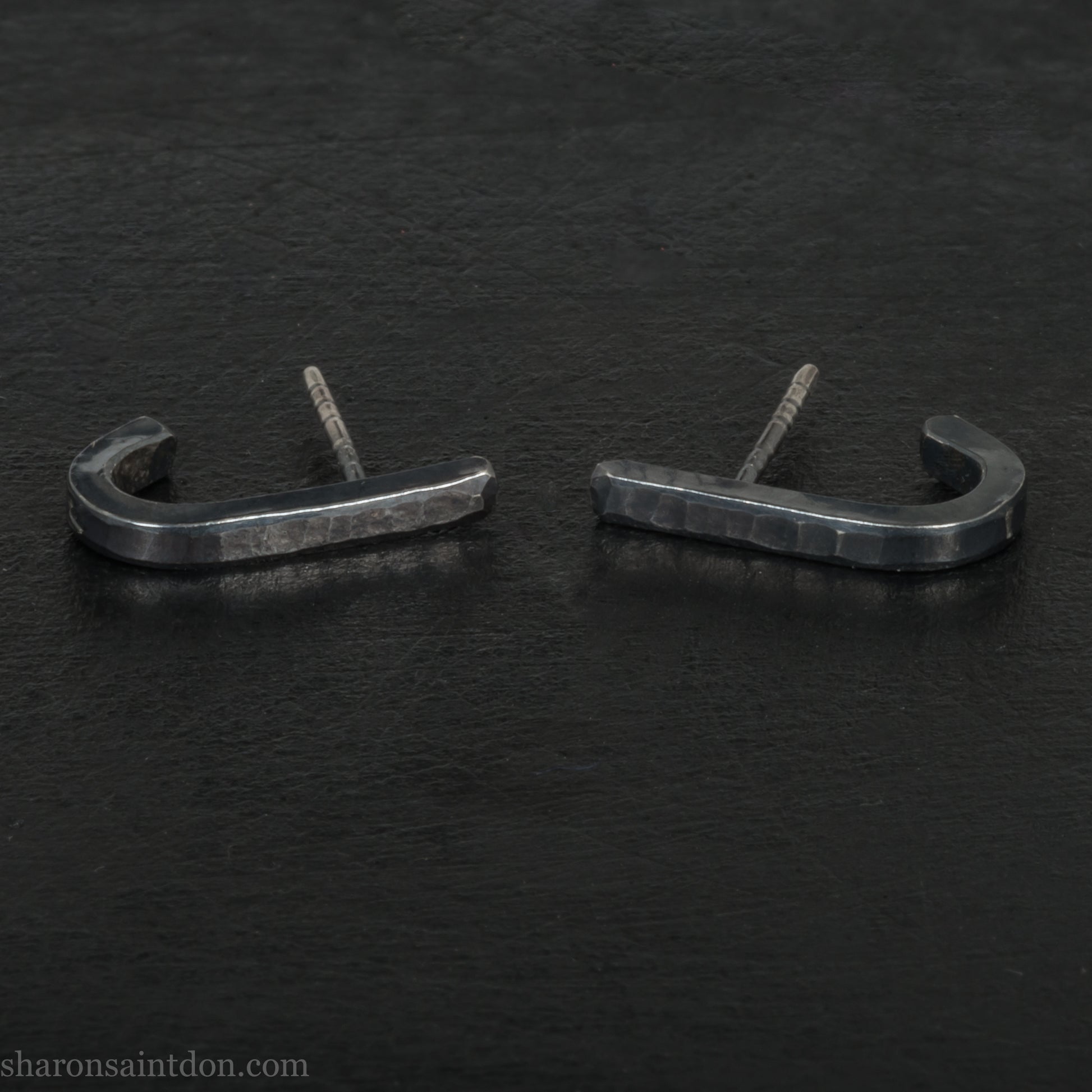 Hand hammered oxidized black sterling silver J-Curve hoop earrings, oxidized black patina.