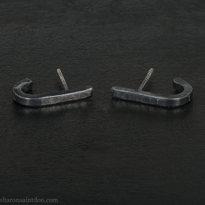 Hand hammered oxidized black sterling silver J-Curve hoop earrings, oxidized black patina.