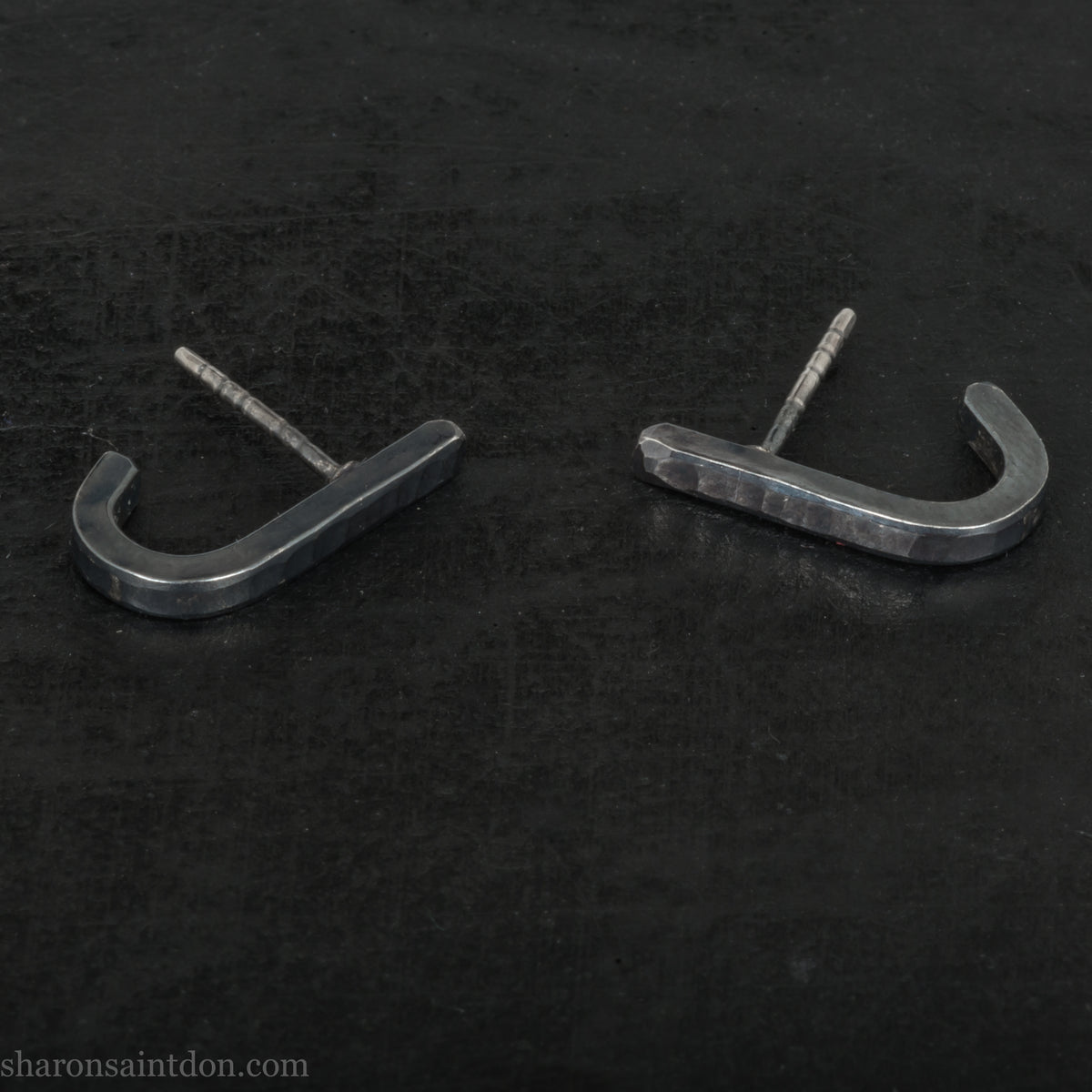 Hand hammered oxidized black sterling silver J-Curve hoop earrings, oxidized black patina.